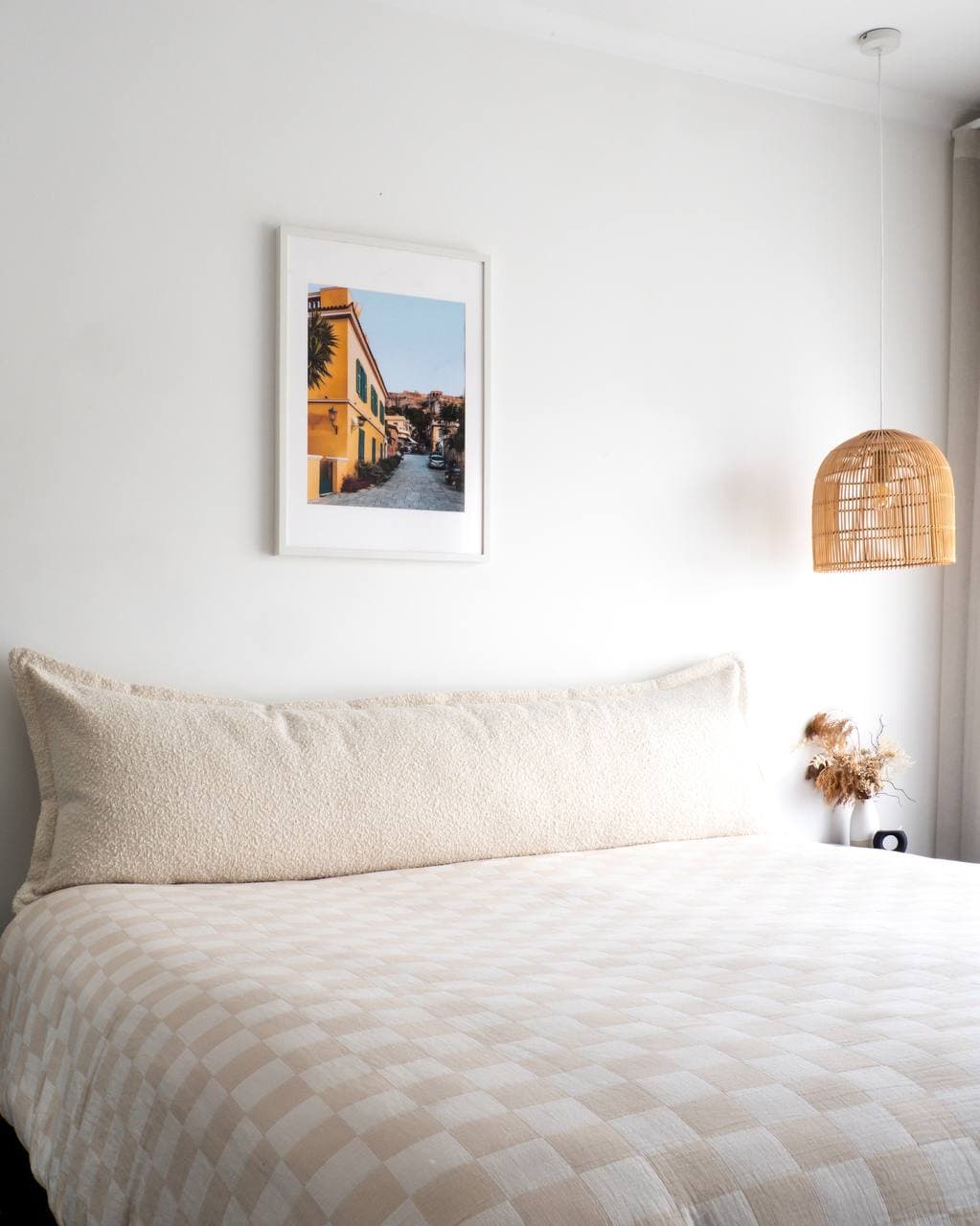 Arlem Bedhead Cushion elegantly arranged with decorative pillows.